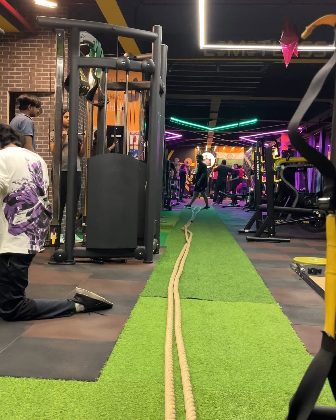 Training floor with battle ropes and neon lights