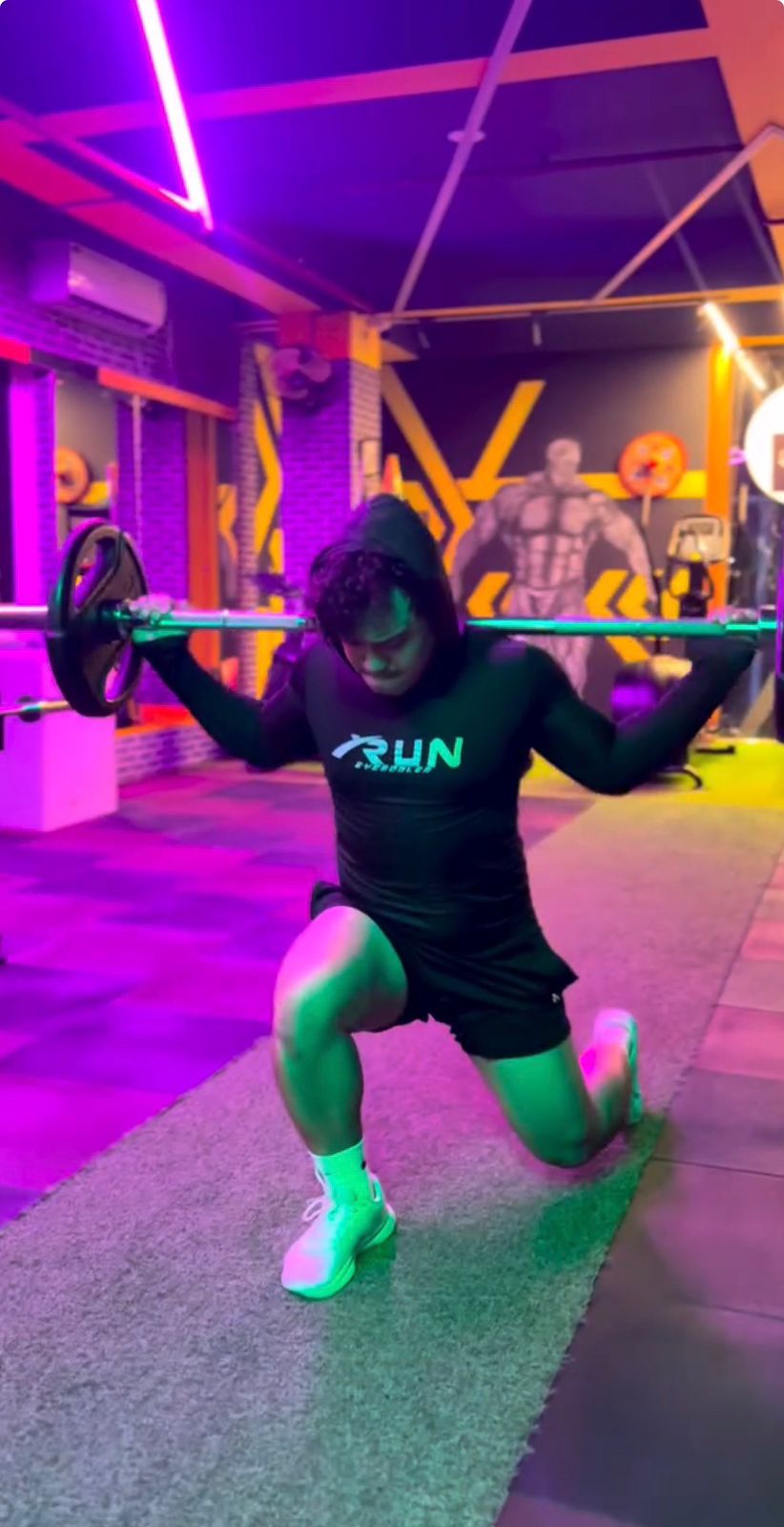 Barbell lunge under neon lights