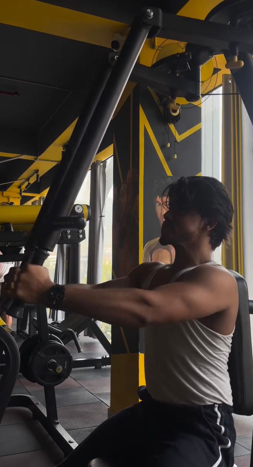 Chest press machine set against the yellow beams
